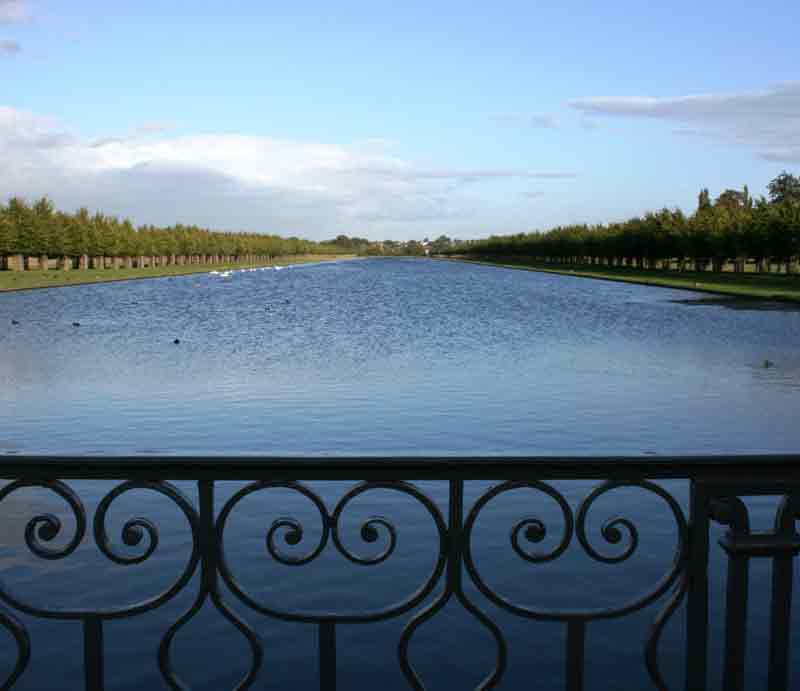 The canal viewed though orante railings.