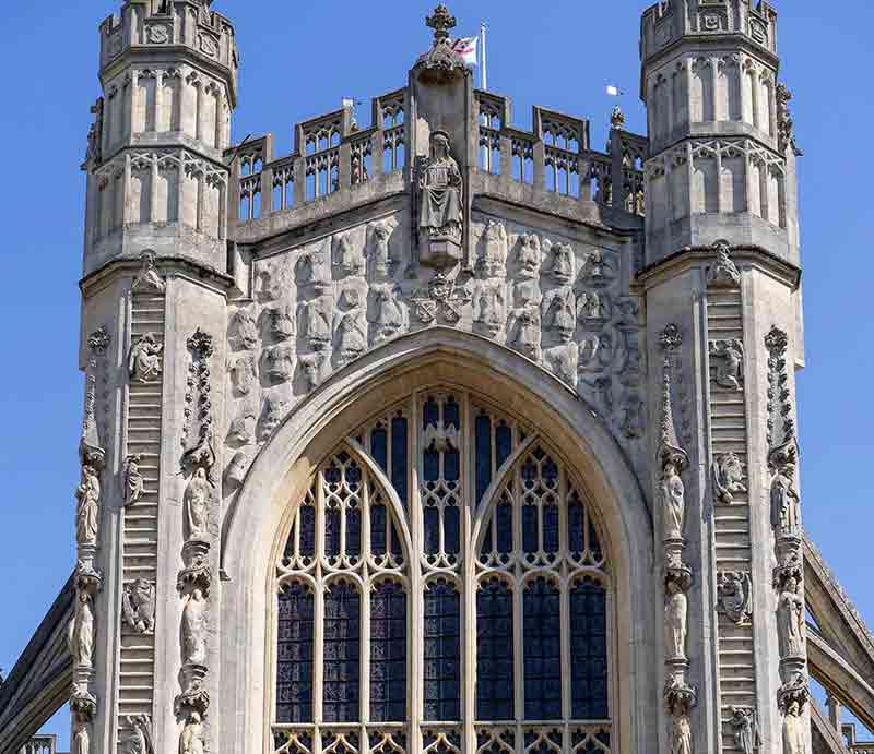 The upper faced from ground level showing stained glass window and turrets.