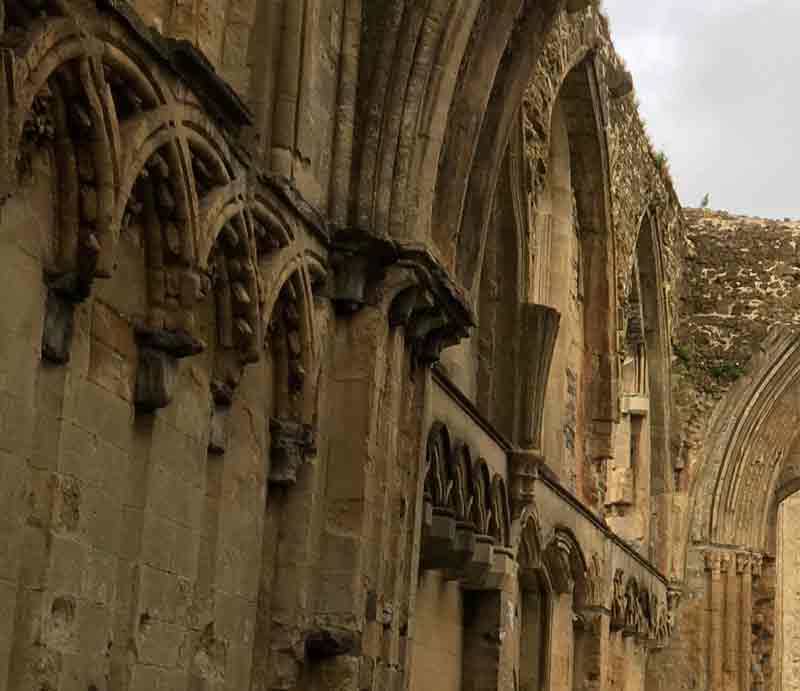 Intricate stone carving and decorative window arches.