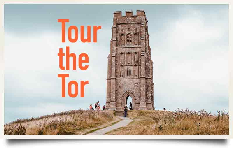 Looking up the hill to the church with caption 'Tour the Tor'.