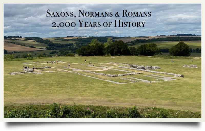 The ruined stone walls with caption 'Saxons, Normans & Romans 2,000 Years of History'.