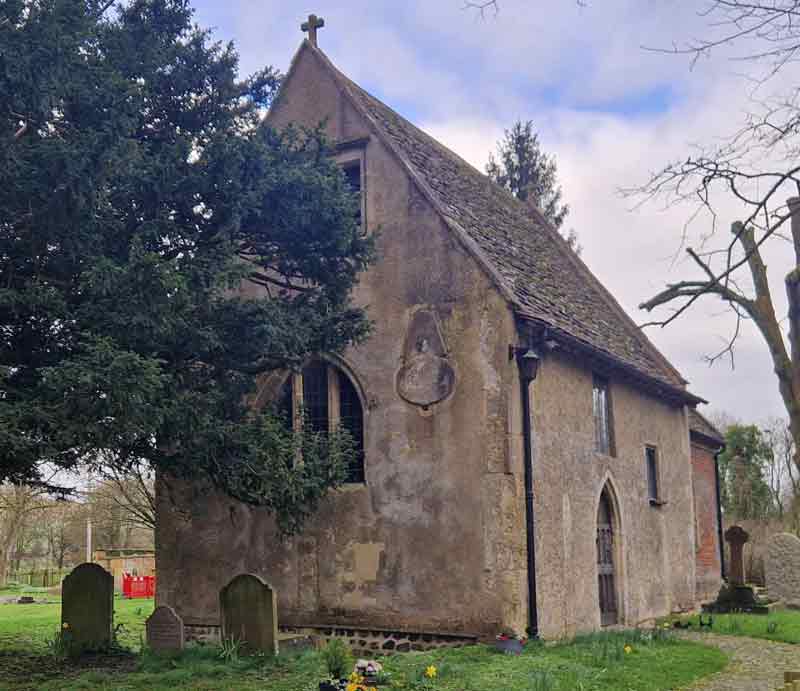 Simple rectangular stone-built Saxon structure within churchyard.