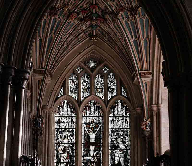 Large stained glass window depicting Christ on the cross.